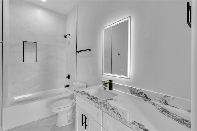 full bathroom with vanity, toilet, and tiled shower / bath