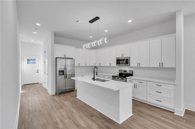 4313 Randolph Ave, New Orleans, LA 70122 - kitchen with appliances with stainless steel finishes, a sink, light wood-type flooring, light countertops, and recessed lighting
