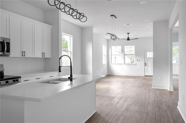 4313 Randolph Ave, New Orleans, LA 70122 - kitchen with a sink, stainless steel appliances, a ceiling fan, light wood finished floors, and recessed lighting