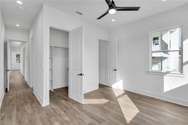 4313 Randolph Ave, New Orleans, LA 70122 - unfurnished bedroom featuring wood finished floors, baseboards, recessed lighting, a walk in closet, and a closet