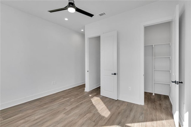 4313 Randolph Ave, New Orleans, LA 70122 - unfurnished bedroom featuring a spacious closet, wood finished floors, a closet, recessed lighting, and baseboards