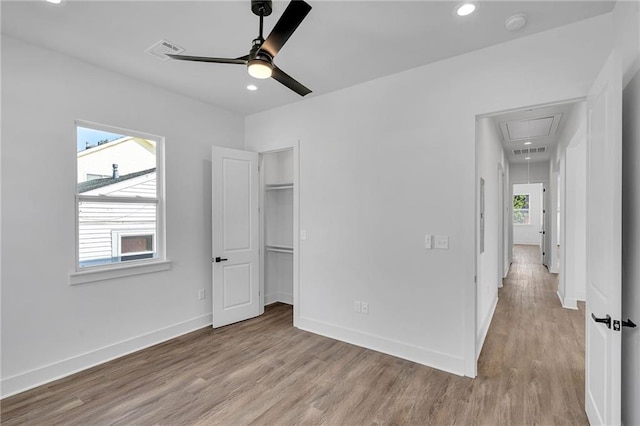 4313 Randolph Ave, New Orleans, LA 70122 - unfurnished bedroom with attic access, wood finished floors, recessed lighting, baseboards, and a walk in closet