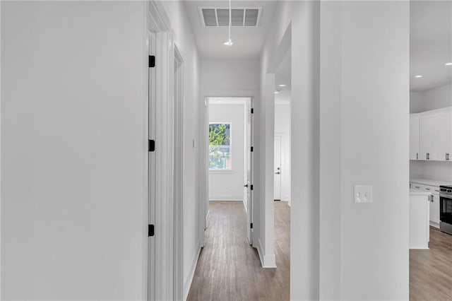 4313 Randolph Ave, New Orleans, LA 70122 - hallway featuring light wood-type flooring and baseboards
