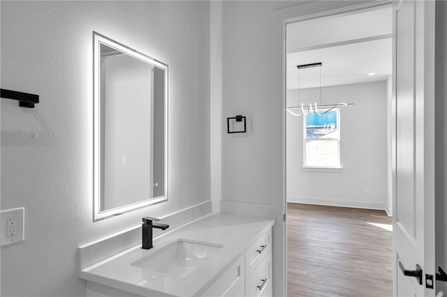 4313 Randolph Ave, New Orleans, LA 70122 - bathroom featuring a sink, wood finished floors, and baseboards