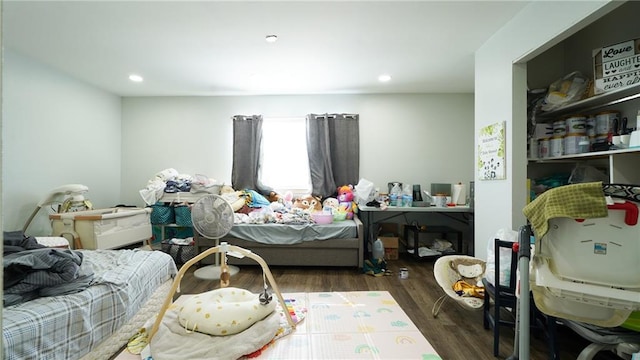 bedroom with dark hardwood / wood-style flooring