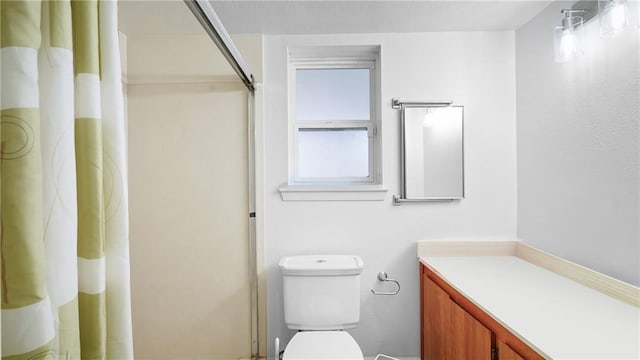 bathroom featuring vanity, a shower with shower curtain, and toilet