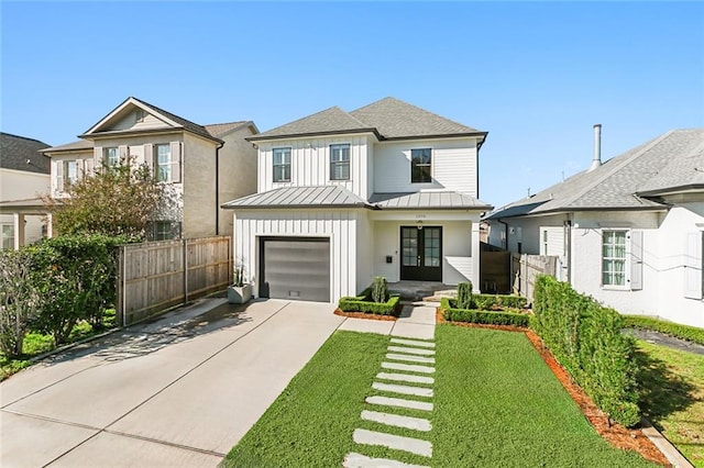 view of front facade featuring a front lawn and a garage