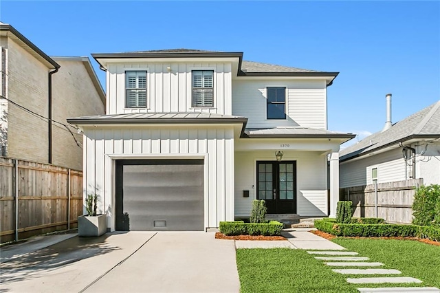 view of front of property featuring a front lawn and a garage