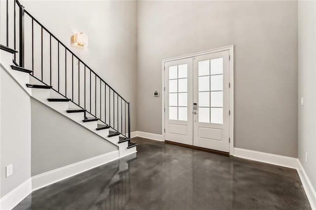 foyer featuring a high ceiling and french doors