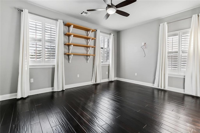 unfurnished room with ceiling fan and dark hardwood / wood-style floors