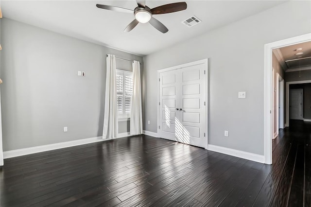 unfurnished bedroom featuring ceiling fan and dark hardwood / wood-style floors