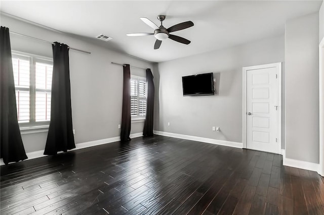 spare room with ceiling fan and dark hardwood / wood-style floors