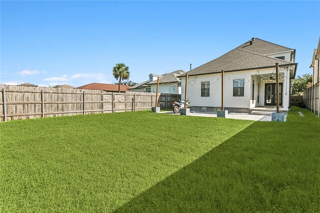 rear view of house with a patio area and a lawn