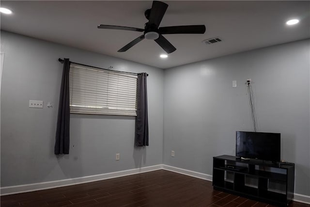 unfurnished living room featuring ceiling fan and dark hardwood / wood-style flooring