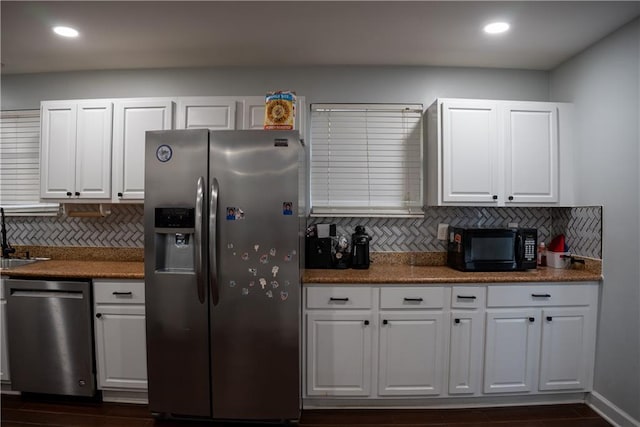 kitchen featuring backsplash, stainless steel appliances, white cabinetry, and sink