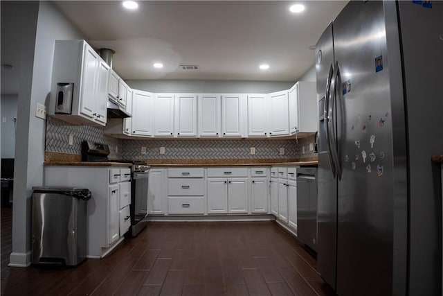 kitchen featuring white cabinetry, dark wood-type flooring, appliances with stainless steel finishes, and tasteful backsplash