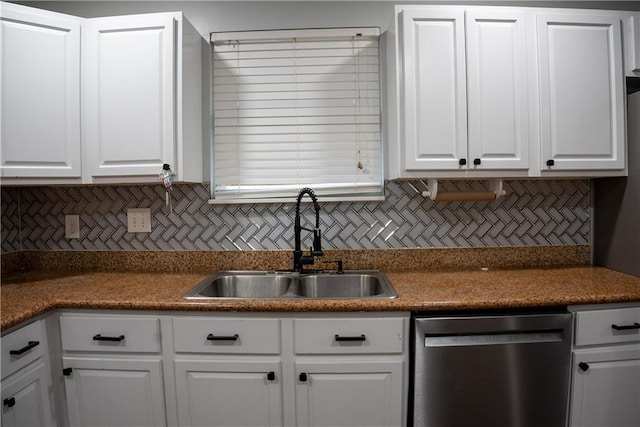 kitchen with backsplash, white cabinetry, stainless steel dishwasher, and sink