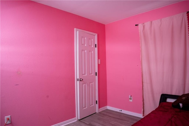 unfurnished bedroom featuring hardwood / wood-style flooring