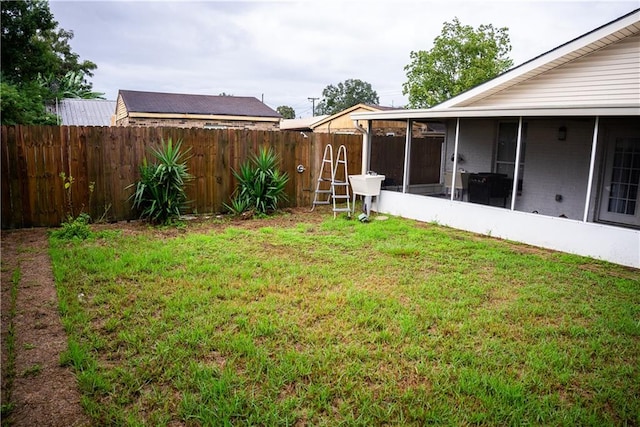 view of yard with sink and a sunroom