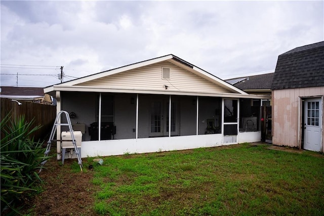 back of house featuring a lawn