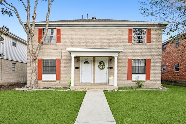 colonial inspired home with a front yard