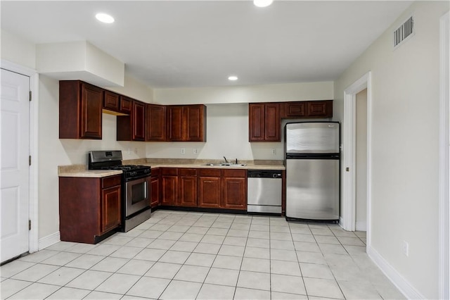 kitchen featuring sink, light tile patterned floors, and stainless steel appliances