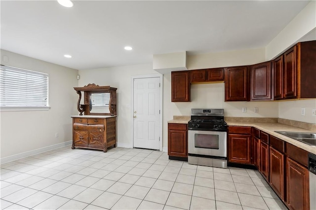 kitchen featuring sink, light tile patterned floors, and stainless steel appliances