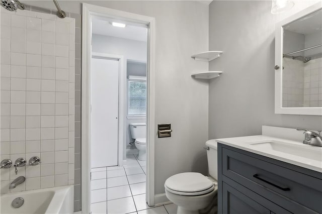 full bathroom with tile patterned floors, vanity, toilet, and tiled shower / bath combo