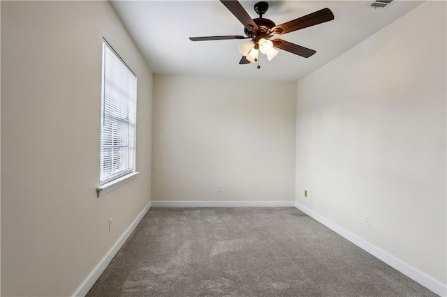 carpeted spare room featuring ceiling fan