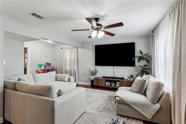 living room with ceiling fan and hardwood / wood-style flooring