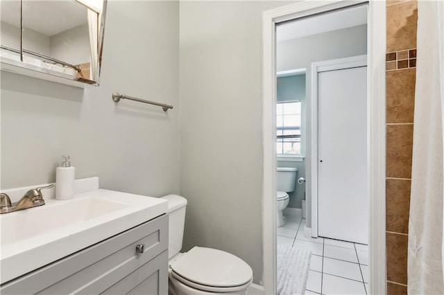 bathroom with tile patterned floors, vanity, and toilet