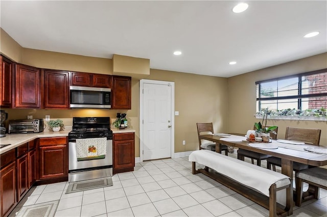 kitchen featuring light tile patterned floors and appliances with stainless steel finishes