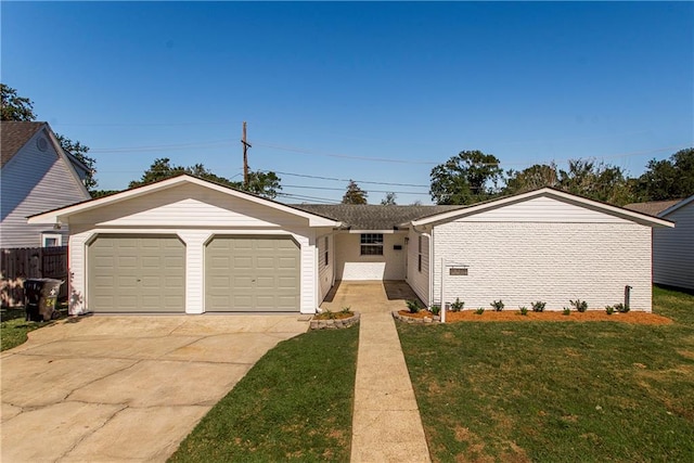 ranch-style house with a garage and a front lawn