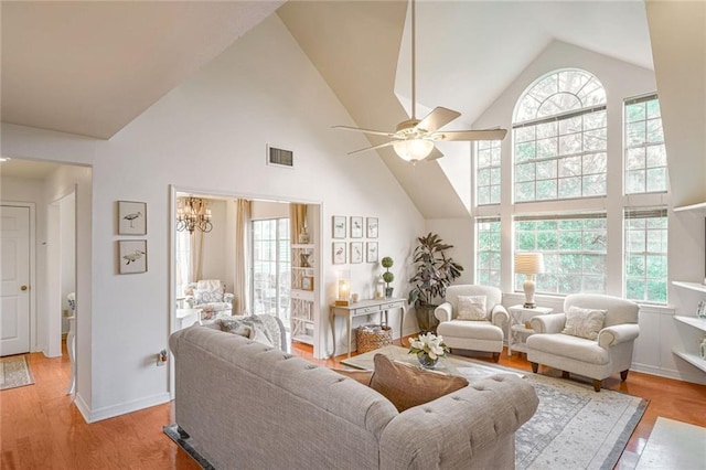 living area featuring a healthy amount of sunlight, visible vents, and wood finished floors