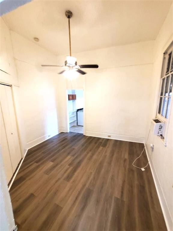 interior space with ceiling fan and dark wood-type flooring