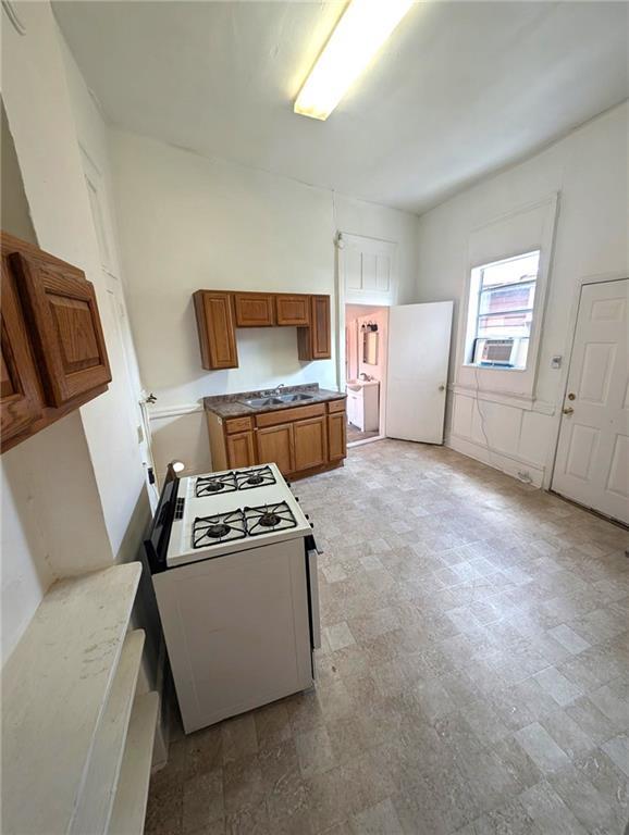 kitchen featuring white stove and cooling unit