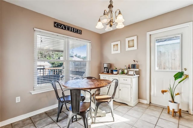 tiled dining area with an inviting chandelier and plenty of natural light