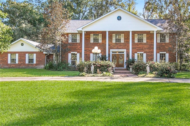 greek revival inspired property with a front yard