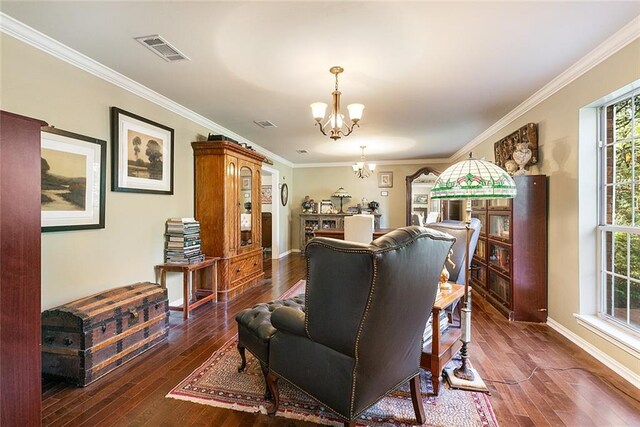 dining room with dark hardwood / wood-style flooring, crown molding, and an inviting chandelier