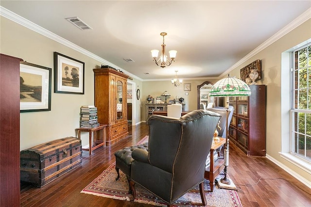 living area with an inviting chandelier, wood-type flooring, visible vents, and ornamental molding