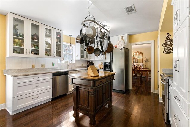 kitchen with white cabinets, stainless steel appliances, and a kitchen island