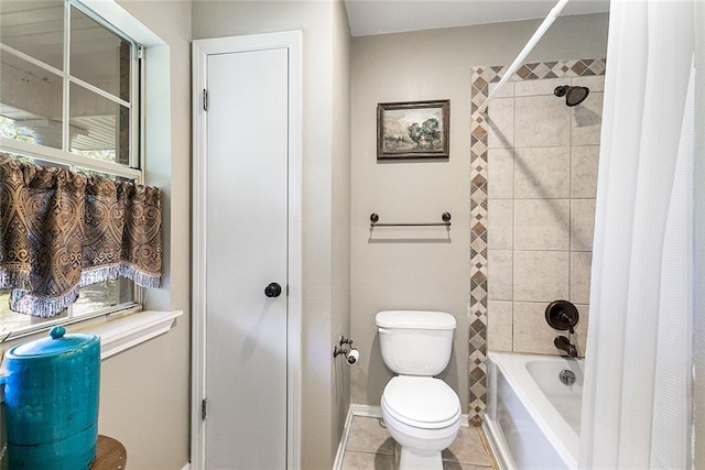 bathroom featuring shower / bath combination with curtain, tile patterned flooring, baseboards, and toilet