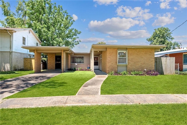 single story home with a front yard and a carport