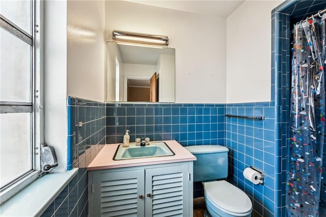 bathroom with vanity, tile walls, and a wealth of natural light