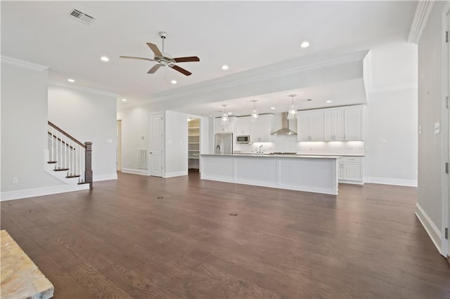 unfurnished living room with ceiling fan, dark hardwood / wood-style flooring, and ornamental molding