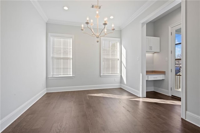 unfurnished dining area with a notable chandelier, built in desk, crown molding, and dark wood-type flooring