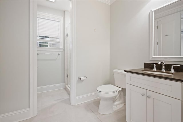 bathroom with tile patterned flooring, vanity, and toilet