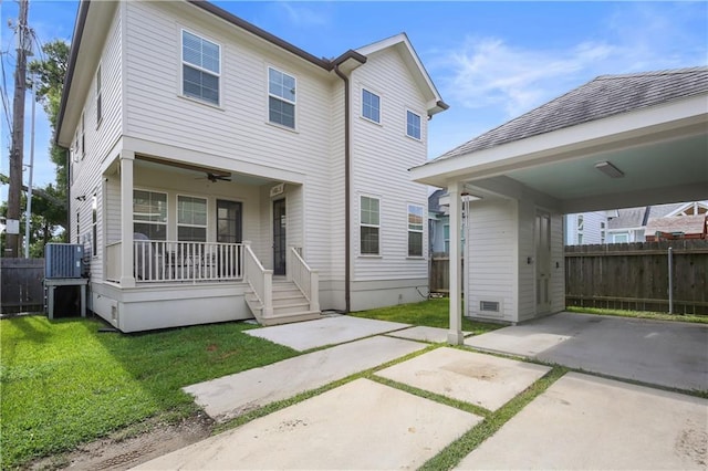 view of front of property with a porch, central AC unit, a carport, and a front lawn