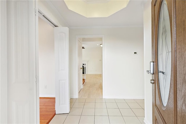 corridor featuring ornamental molding and light wood-type flooring