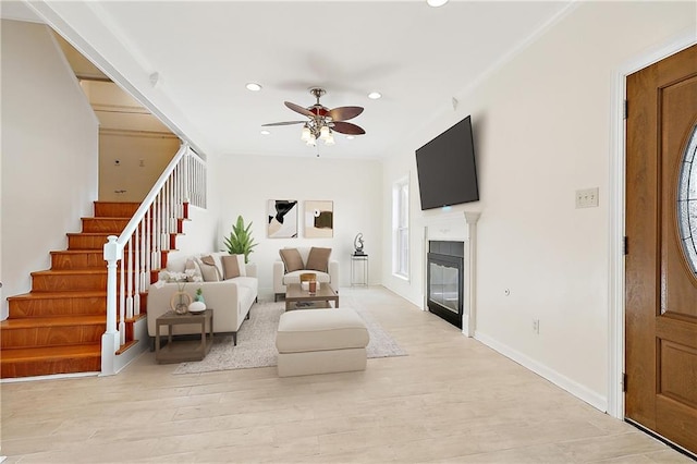 living room featuring ceiling fan and light wood-type flooring